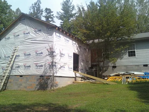 Tyvek wrapped gable on a new room addition beside an existing home in Harwood